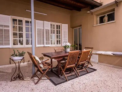 a wooden table and chairs on a patio at Apartment Casa dei Mori by Interhome in Terrasini