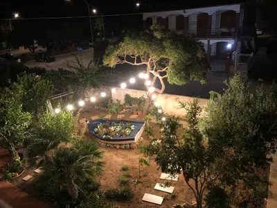 an overhead view of a garden at night with lights at B&B il Colibrì in San Vito lo Capo