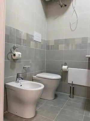 a bathroom with a toilet and a sink at 38 Aira Hotels in Palermo