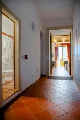 a hallway with a bathroom with a sink and a mirror at Ballaro' Hotel - Budget Room in Palermo
