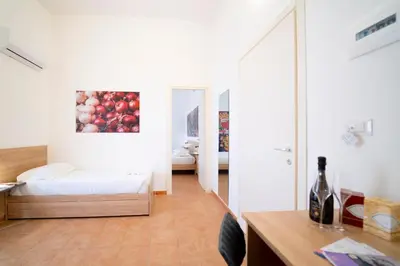 a room with a bed and a painting of apples at Ballaro' Hotel - Budget Room in Palermo