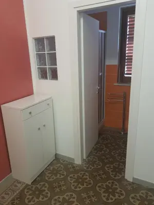 a room with a white cabinet and a door at Casa vacanza Raggio di Sole in Castellammare del Golfo