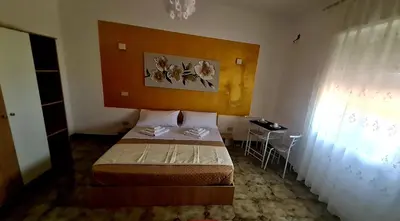 a small bedroom with a bed and a table at Le Terre di Sicilia in Terrasini