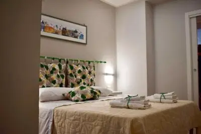 a bedroom with a large bed with towels on it at La Casa Dei Leoni Di Sicilia in Palermo