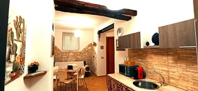 a kitchen with a sink and a table with a dining room at Ai Normanni in Palermo