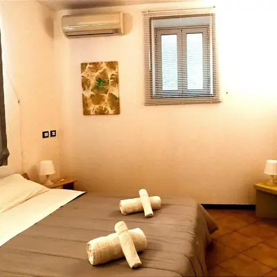 two towels on a bed in a bedroom at Ai Normanni in Palermo