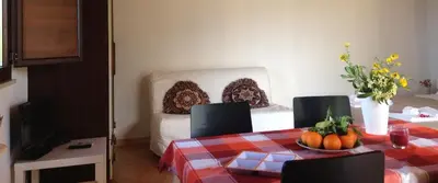 a bedroom with a bed and a table and chairs at Baglio Fico in Castellammare del Golfo