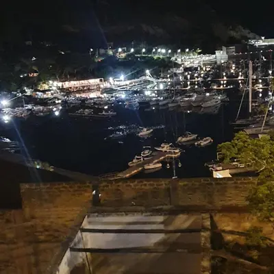 a harbor at night with boats in the water at Mary Gery's Rooms in Castellammare del Golfo