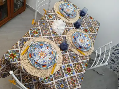 a table with plates and hats on top of it at Mary Gery's Rooms in Castellammare del Golfo