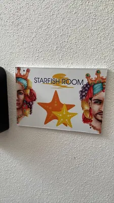 a starfish room sign hanging on a wall at Mary Gery's Rooms in Castellammare del Golfo