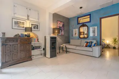 a living room with a couch and a refrigerator at Villetta Cicciuli in Altavilla Milicia