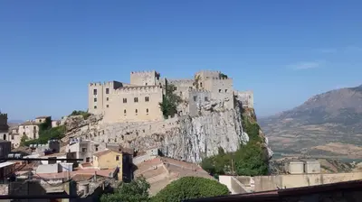 a castle perched on top of a mountain at La casa del custode in Caccamo