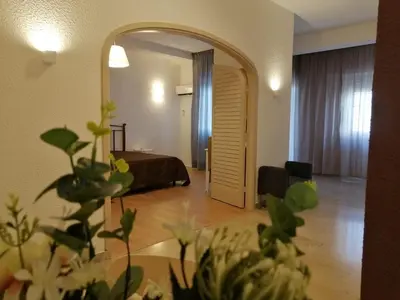 a room with a bed and a large mirror at 100 PASSI Politeama in Palermo