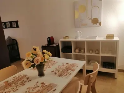 a dining room table with a vase of flowers on it at 100 PASSI Politeama in Palermo