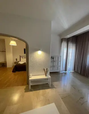 a living room with a mirror and a room with a bed at 100 PASSI Politeama in Palermo