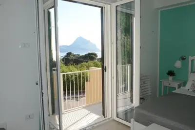 a sliding glass door with a view of a balcony at I colori del mare in Macari