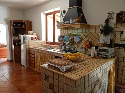a kitchen with a counter with a bowl of fruit on it at Villa Barone in Castellammare del Golfo