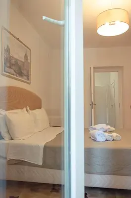 a bedroom with a bed with towels on it at Bonorum Santa Sofia in Palermo