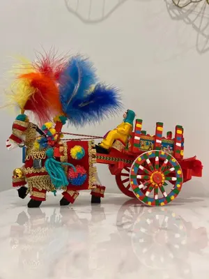 a figurine of a toy horse pulling a cart at Maqueda Suites in Palermo
