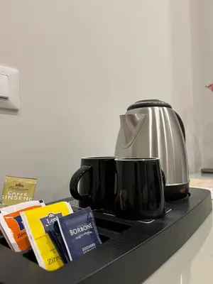 a counter top with two coffee cups and a toaster at Maqueda Suites in Palermo