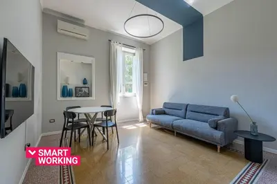 a living room with a couch and a table at Dante Design Apartment by Wonderful Italy in Palermo