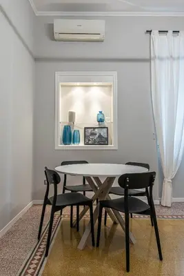 a bedroom with a bed and a mirror and a chair at Dante Design Apartment by Wonderful Italy in Palermo