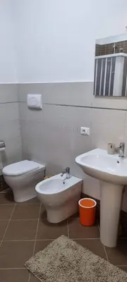 a bathroom with a sink and a toilet and a bidet at ADRIANA SEAHOUSE in Balestrate
