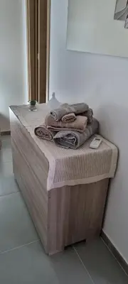a pile of towels sitting on a counter in a room at ADRIANA SEAHOUSE in Balestrate