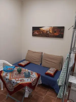 a blue couch with a table in a room at CASA VACANZA DI VIA GIACALONE in Palermo