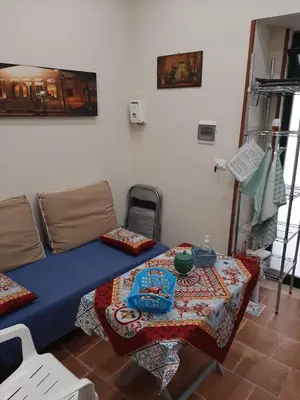 a room with a bed and a table in it at CASA VACANZA DI VIA GIACALONE in Palermo