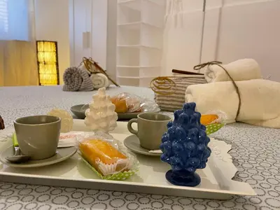 a tray with cups and food on a table at Casa vacanze Baglio Barcellona Mondello in Palermo