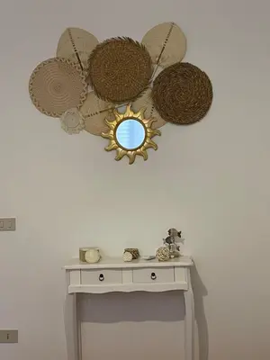 a room with a table with a mirror on the wall at Casa vacanze Baglio Barcellona Mondello in Palermo