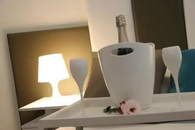 a white shelf with a lamp and a bottle of wine at meloluxuryhouse in Palermo