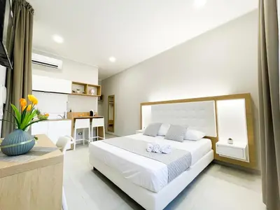 a bedroom with a white bed with two towels on it at Alba e Tramonto in San Vito lo Capo