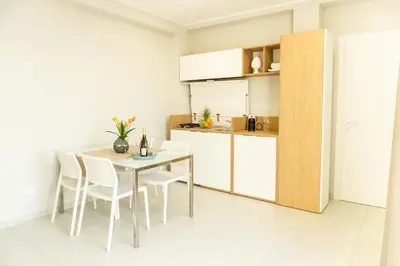 a kitchen and dining room with a table and chairs at Alba e Tramonto in San Vito lo Capo