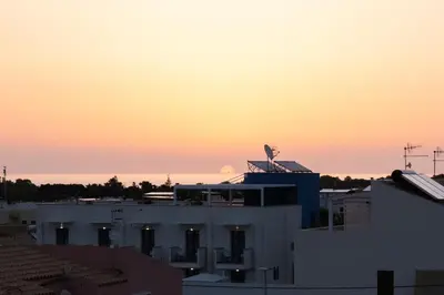 a building with a bird on top of it at sunset at Alba e Tramonto in San Vito lo Capo