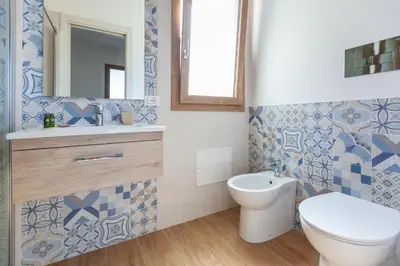 a bathroom with a toilet and a sink and a mirror at LA DAMA in San Vito lo Capo