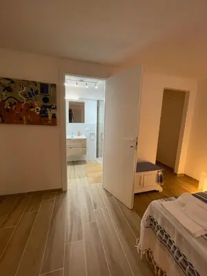 a bedroom with a bed and a bathroom at Surfinia’s home in Palermo