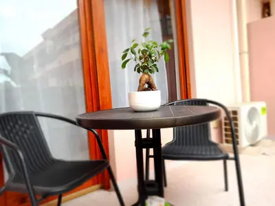 a living room with a table with a lamp and a blue couch at Oasi home in Casteldaccia