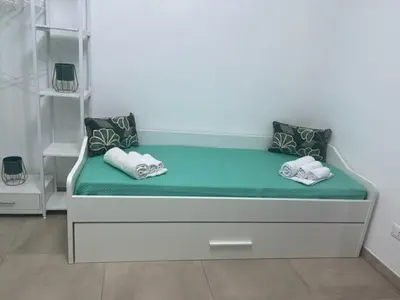 a bedroom with a large white bed in a room at Makari Our Angel in Macari