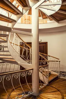 a spiral staircase in a building with a ceiling at Hotel Sirenetta in Isola delle Femmine