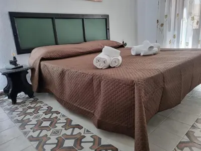 a bedroom with a bed with two towels on it at Casa viotti Le fuoriserie in Palermo
