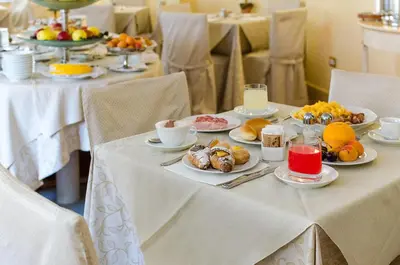 a table topped with plates of food and fruit at Hotel Vecchio Borgo in Palermo