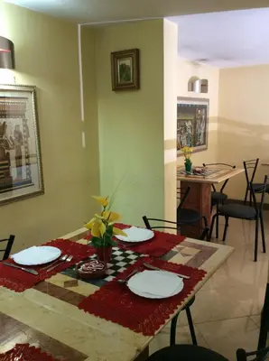 a dining room with a table with chairs and a tableablish at Albergo Verdi in Palermo