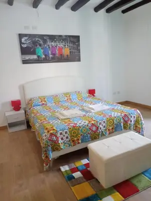 a bedroom with a bed with a colorful quilt at Mi casa es tu casa in Palermo