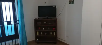 a television on a stand in a room at Mi casa es tu casa in Palermo