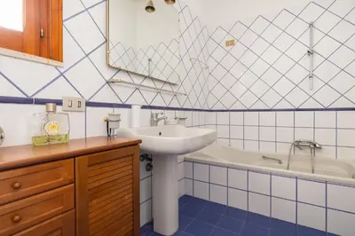 a bathroom with a sink and a bath tub at Villa vista mare con piscina privata a Mondello in Palermo
