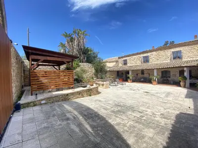 a courtyard with a wooden pavilion in a building at Baglio Giganti in Alcamo