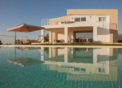 a house with a swimming pool and an umbrella at Villa Lombardo Luxury in Balestrate