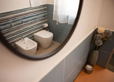 a mirror in a bathroom with a toilet and a sink at Villa Lombardo Luxury in Balestrate